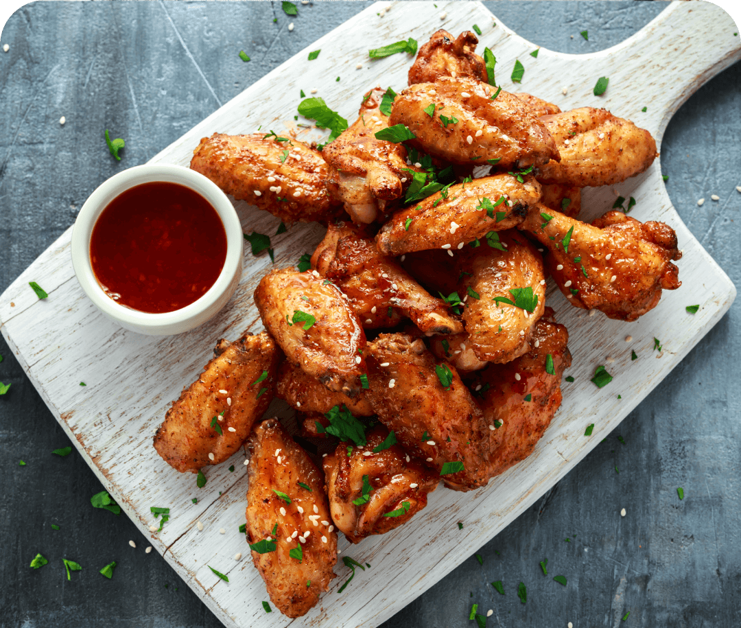 Spicy chicken wings with dipping sauce.